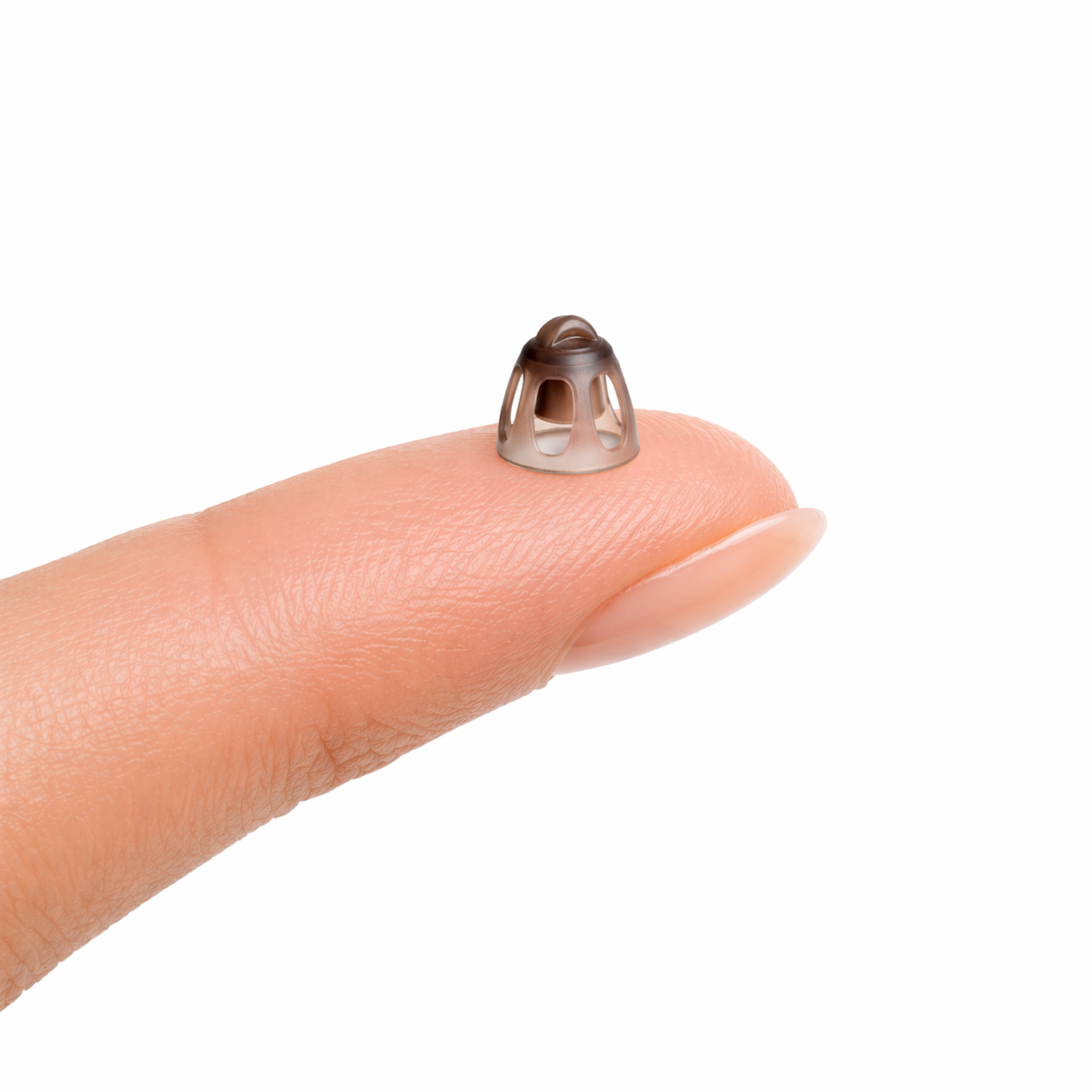 Small 8mm open dome on a person's finger against a white background