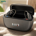 A pair of Ear Ascend Bluetooth Rechargeable Premium RIC hearing aids in a dark gray charging case with an open lid, placed on a textured beige fabric surface. The brand name 'eara' is visible in the top left corner.