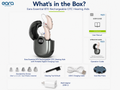 Box contents overview for the Eara Essential BTE Rechargeable OTC Hearing Aids, showing the open dark gray and beige charging case with a beige hearing aid inserted, plus included accessories: standard ear cones, cleaning tool and brush, USB-C charging cable, wall adapter, and wax filters. Text on the page reads 'What's in the Box?' and 'Eara Essential BTE Rechargeable OTC Hearing Aids with Portable Digital Charging Case.