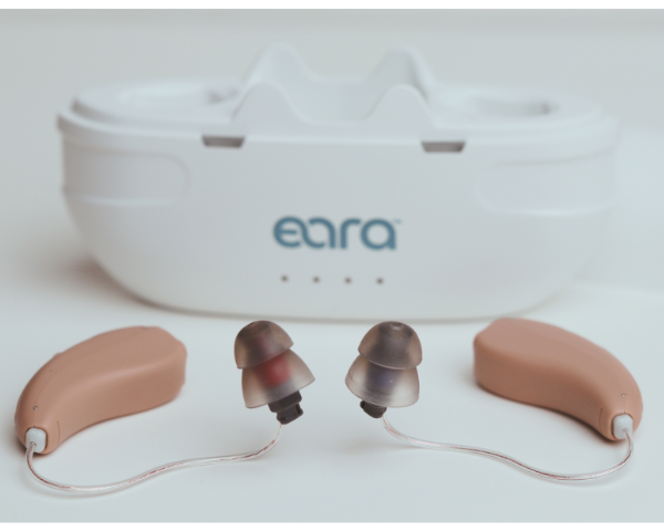 Eara hearing aids with a white case featuring the 'eara' brand on a light background with large power domes on the ends.