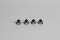 four small open domes on a light grey background